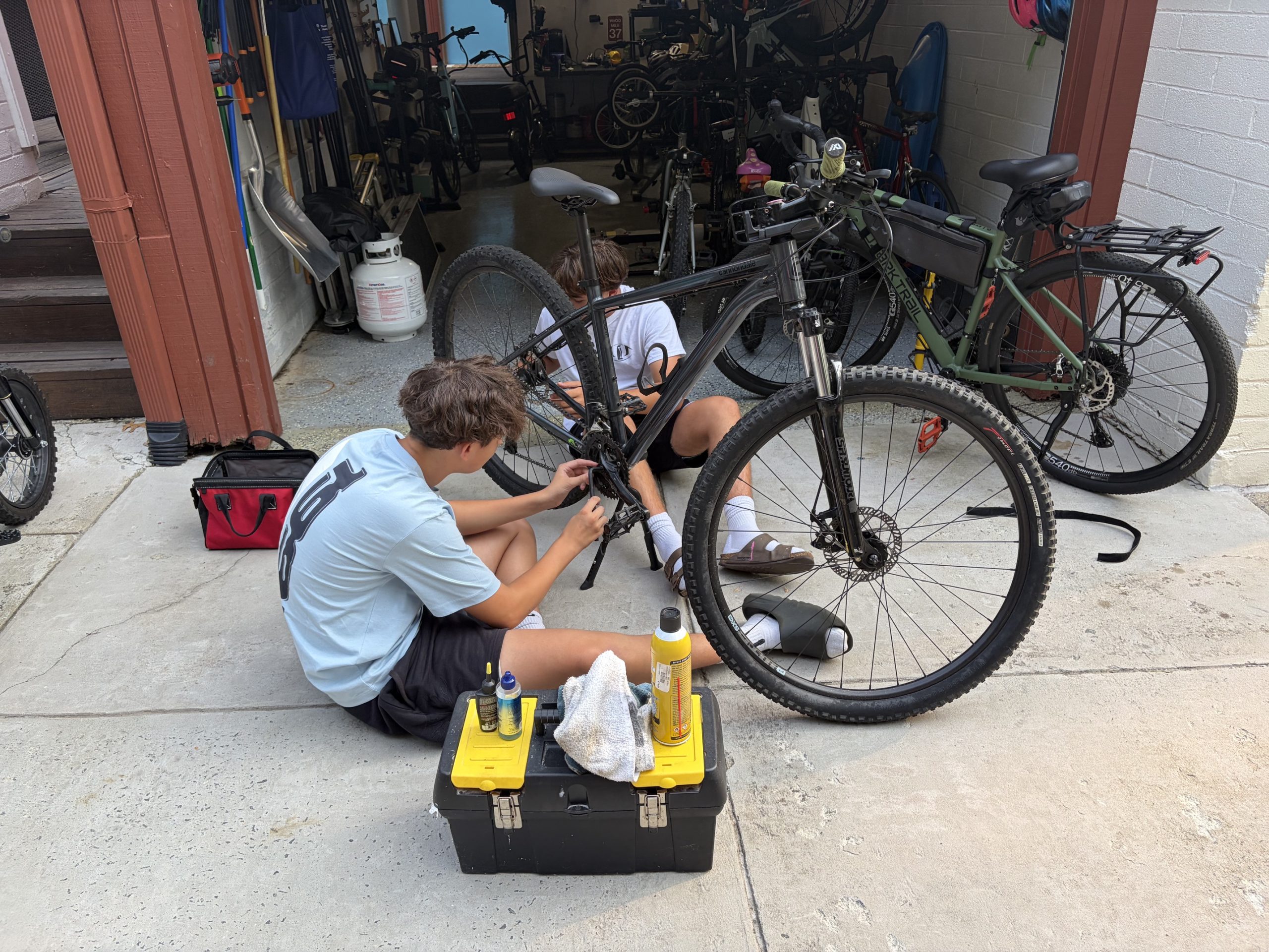 Success Cycles founders repairing a donated bike