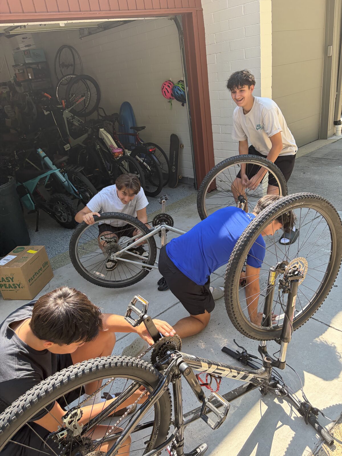 The Success Cycles team inspecting and repairing donated bikes